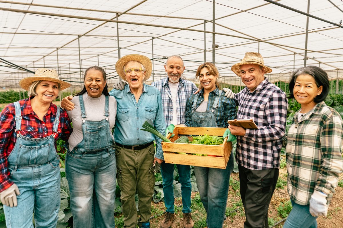 A group of ordinary people gathered together, smiling
